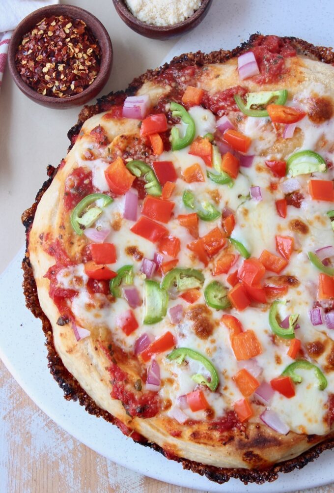 whole cooked pizza on marble serving tray