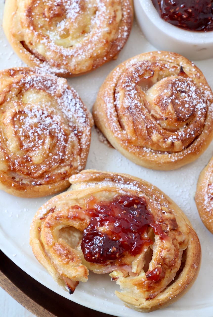 monte cristo rolls topped with raspberry jam on a plate